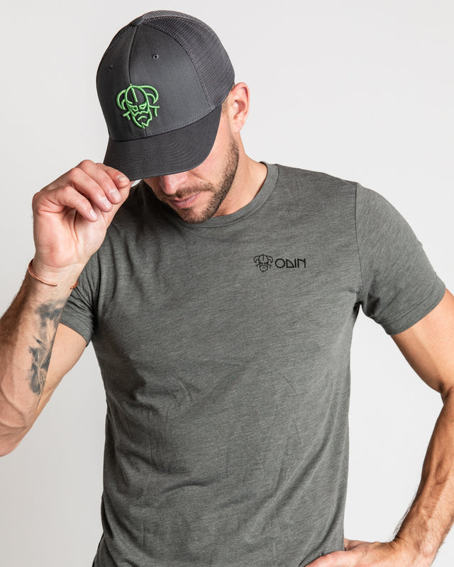 Green Men's disc golf t-shirt front view of model, showcasing Charcoal snapback disc golf hat with large green embroidered Odin logo
| Odin Disc Golf Apparel